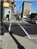 A corner of Columbia Street with new paving, ramps, and crosswalk paint